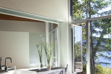 Bathroom with Aluminum Windows Overlooking the Lake Shuswap Cabin by Splyce Design