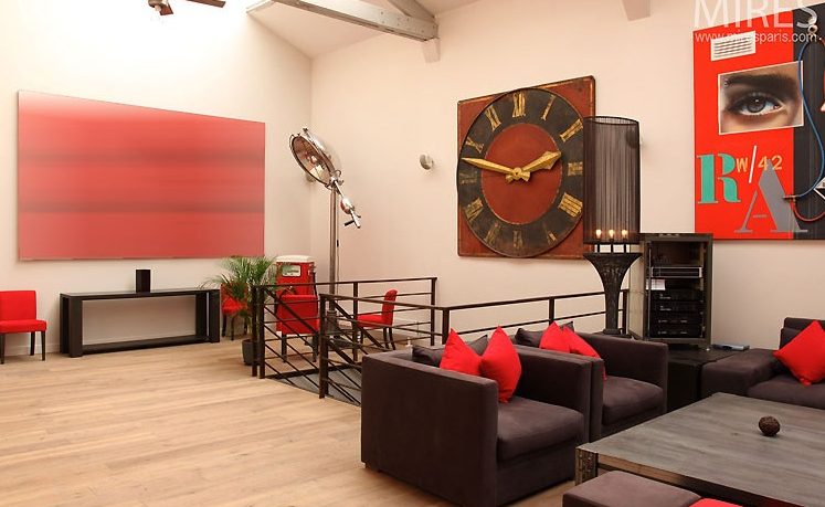 Cool Loft with Red Art and Black Furniture in Paris