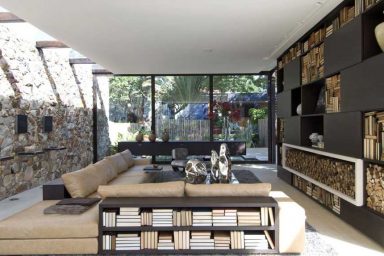 Elegant Living Area with View of Yard and Stone Wall