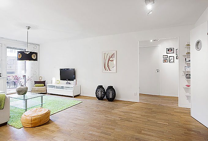 White Living Room Apartment with Black Chandelier and Wood Floor