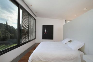 White Second Bedroom with Large Glass Window