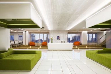 Bright Colored Office Receptionist and Waiting Room with Green Sofas