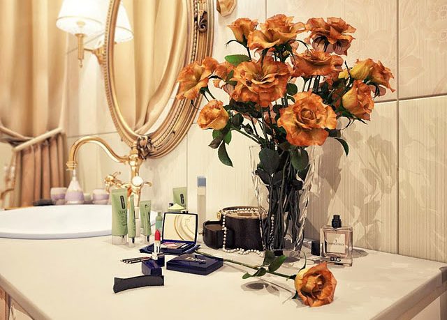 Orange Flowers in a Warm Sink Bathroom
