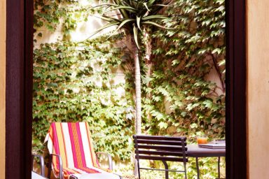 Small Courtyard with Palm Tree and Outdoor Chair