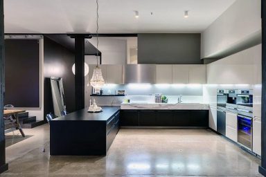 Black Kitchen Countertop with Polished Concrete Floors