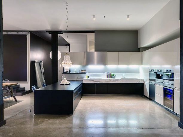 Black Kitchen Countertop with Polished Concrete Floors
