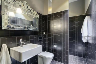 Black Tile Wetroom Design with White Washbasin