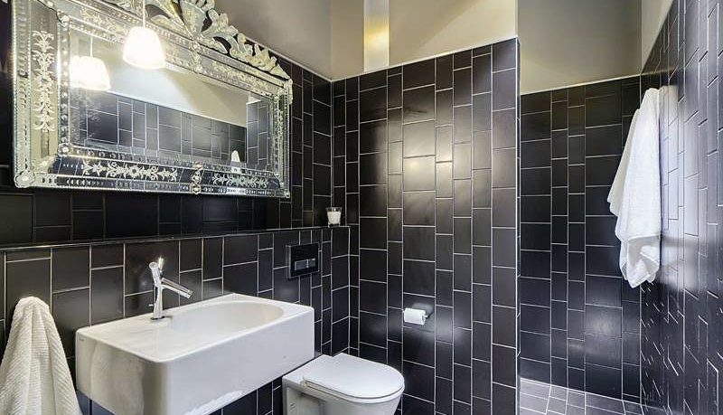Black Tile Wetroom Design with White Washbasin