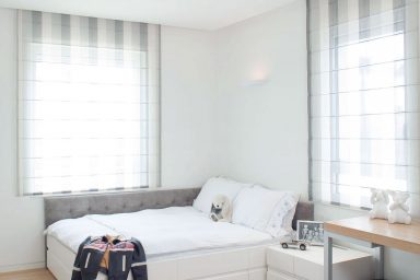 Bright White Girls Bedroom With Wooden Floor