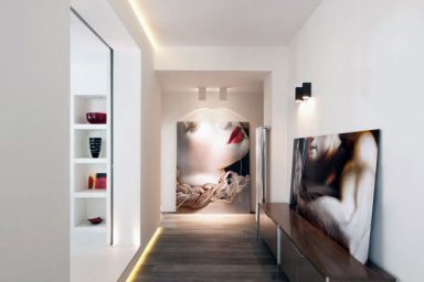 Modern Hallway with Recessed Wall Lighting and Wooden Floor