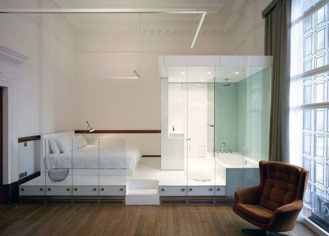 Unique White Bedroom Bed and Bathtub in One Area