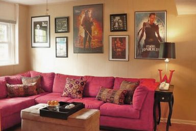 Small Movie Room Design with Pink Sofa and Movie Posters