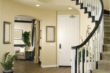 Modern entry way with wood floor and winding stairs