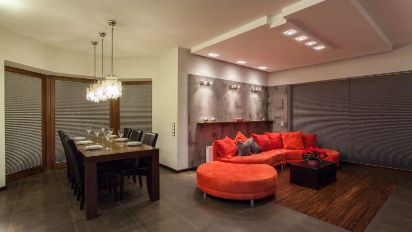 Unique dining room with red couch and solid table