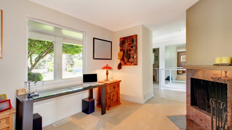 Small living room with desk and fireplace