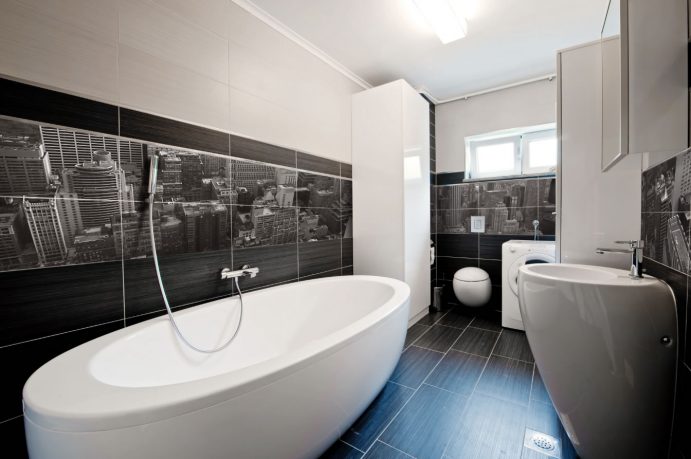 Modern bathroom with mural and white tub